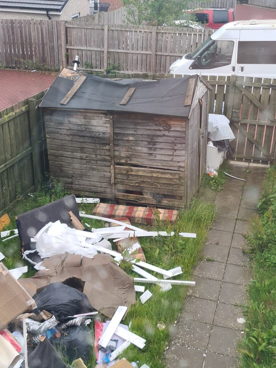 Garden full of bags, boxes and broken furniture